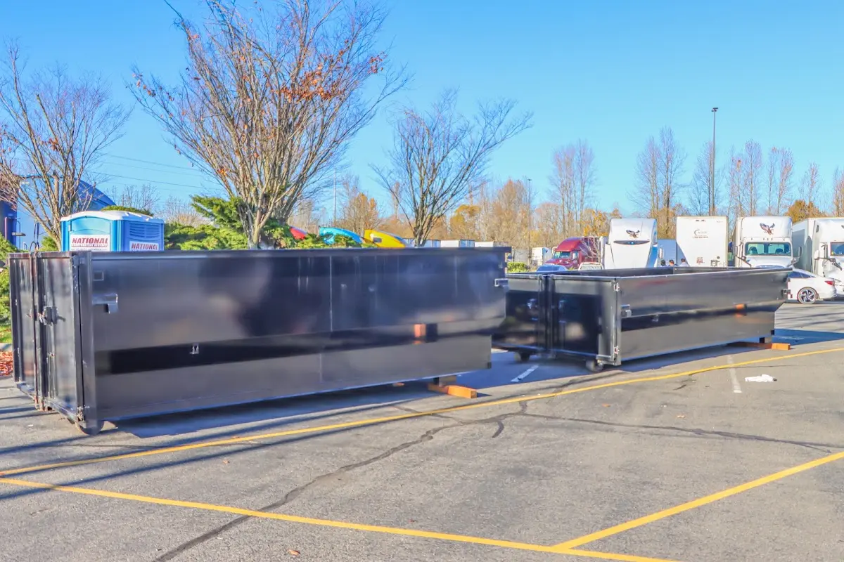 Professional dumpster rental service with roll-off container on residential driveway in Daytona Beach